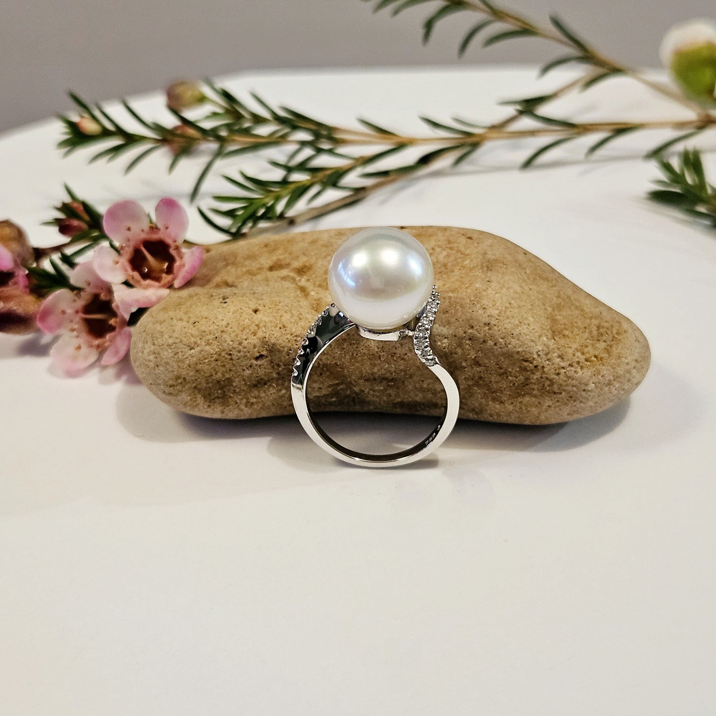 Pearl ring with sweeping diamond set shoulder