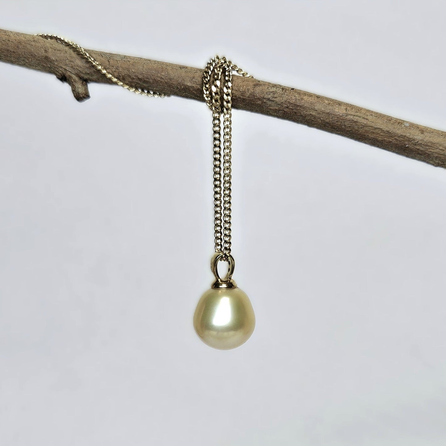 Golden pearl pendant